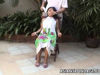 Busty Asian teen gets tied up and handcuffed to chair in BDSM scene